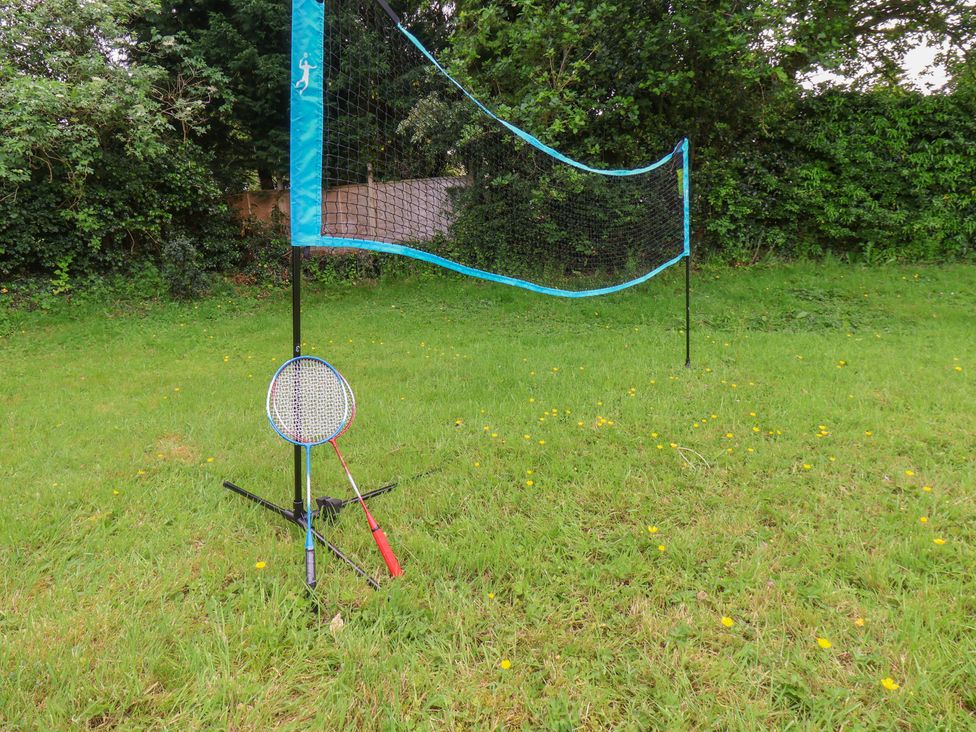 A badminton net with rackets on a grass area at 21 Eskdaleside Sleights