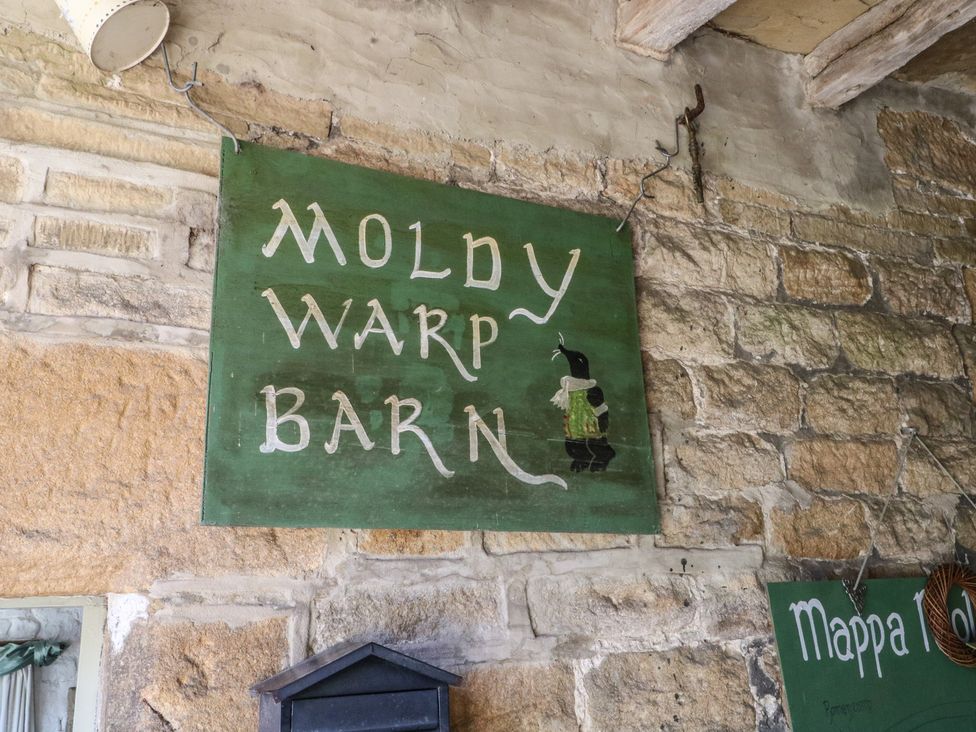 A sign indicating Moldy Warp Barn at Moldy Warp Barn in Haworth