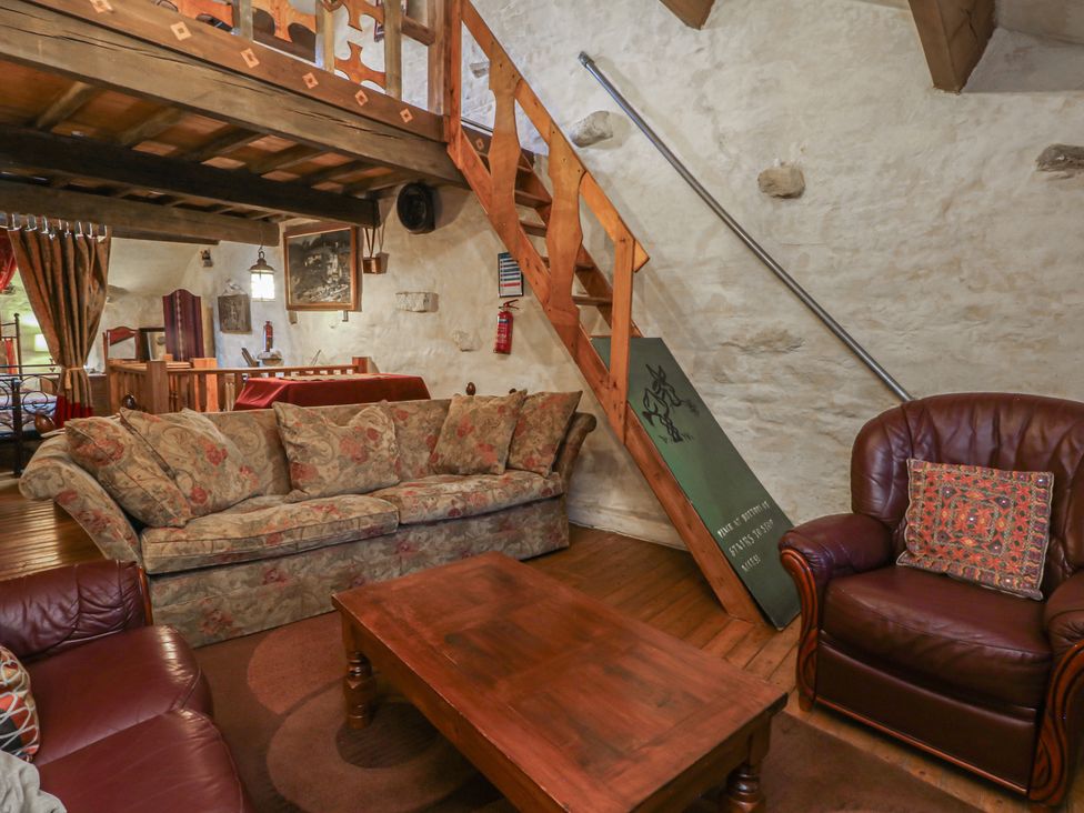 A living room with a sofa and armchair at Moldy Warp Barn in Haworth