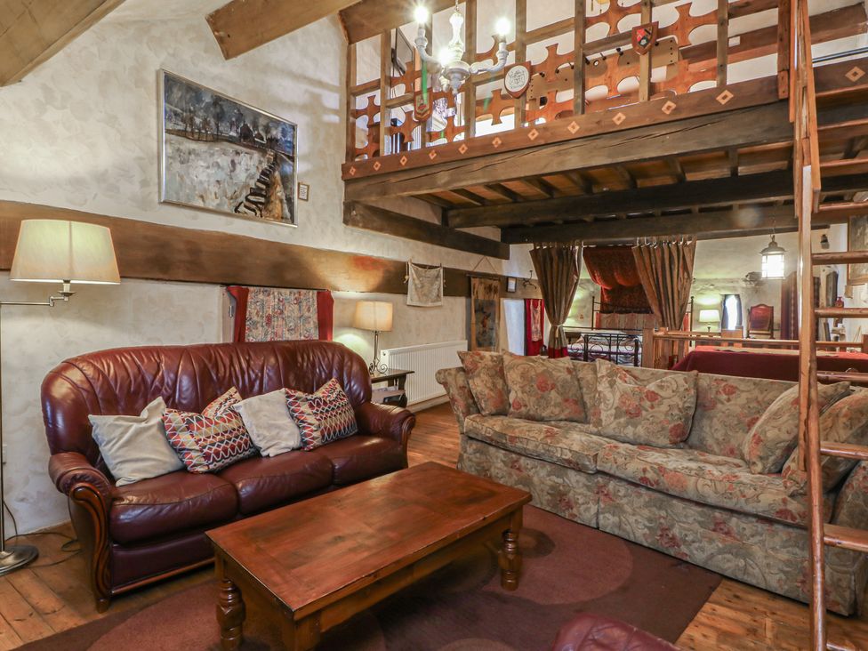 A living room with a sofa and coffee table at Moldy Warp Barn in Haworth