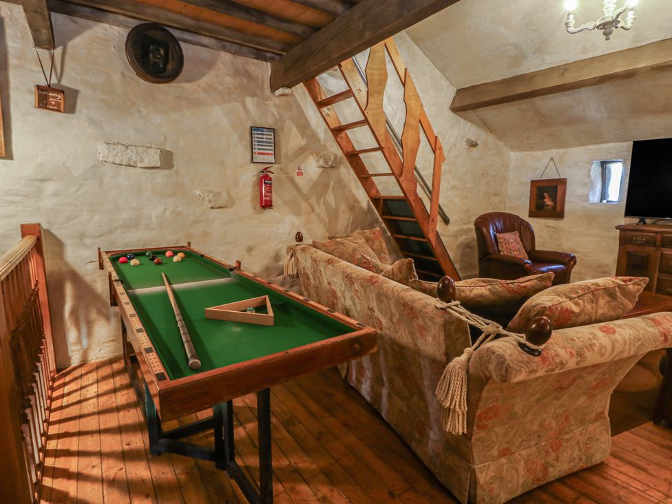 A snug with a pool table and sofa at Moldy Warp Barn in Haworth