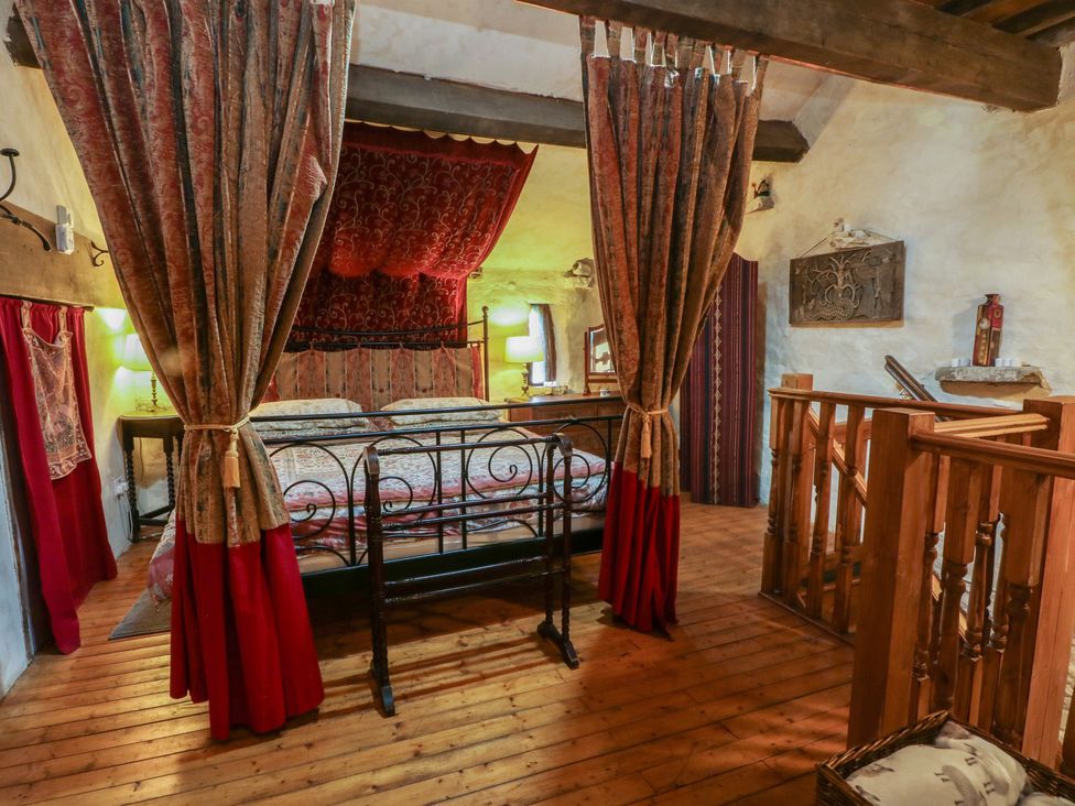 A bedroom with a bed and wooden railing at Moldy Warp Barn in Haworth