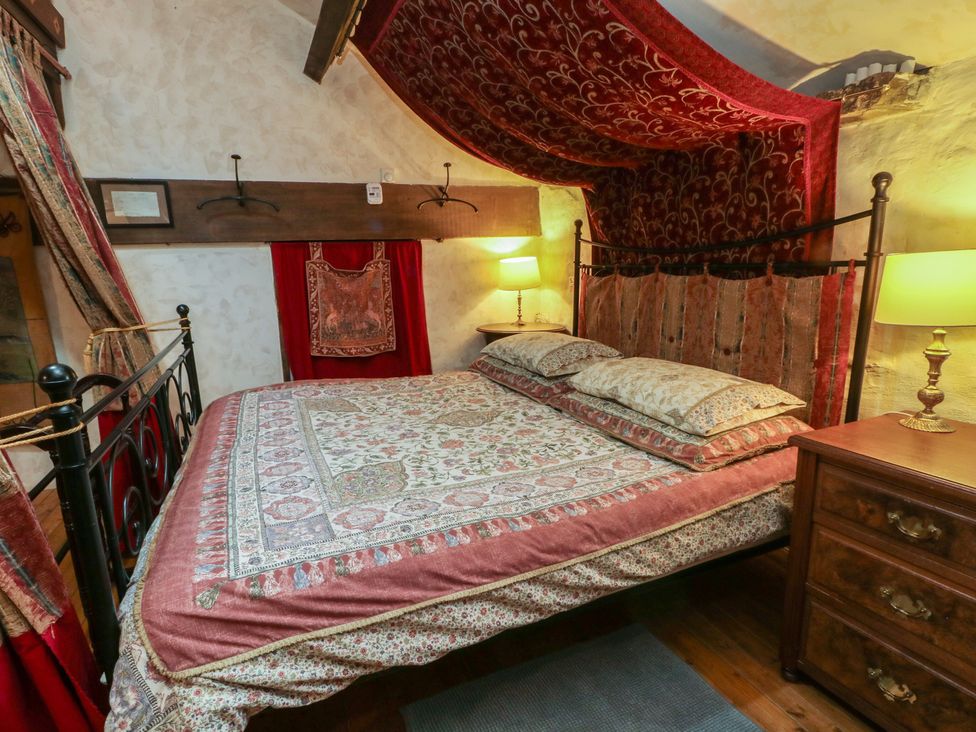 A bedroom with a bed and lamp at Moldy Warp Barn in Haworth