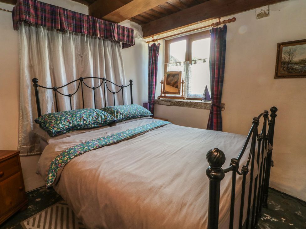 A bedroom with a bed and a window at Moldy Warp Barn in Haworth