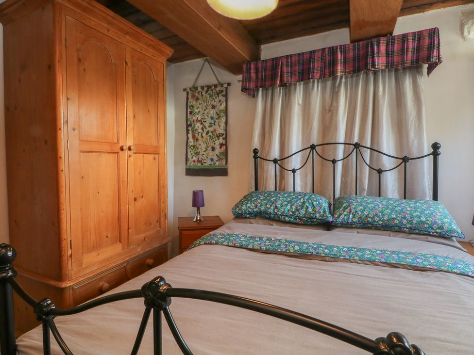 A bedroom with a bed and wardrobe at Moldy Warp Barn in Haworth