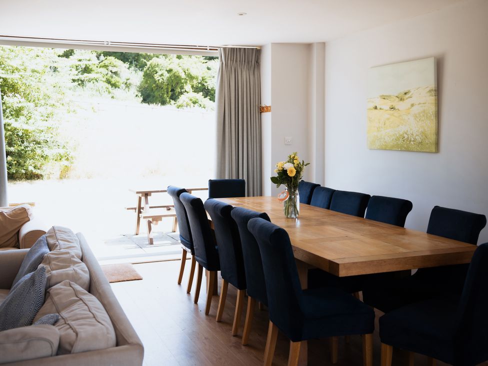 A dining room with a table and chairs at Newfield Farm Cottages in Pimperne near Blandford Forum