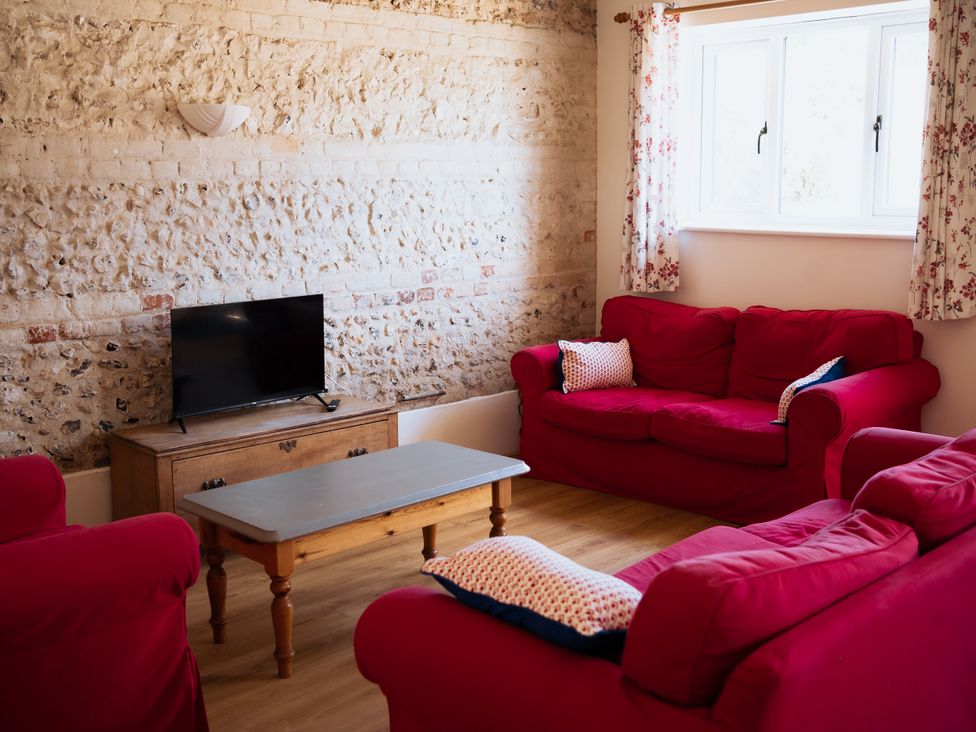 A living room with a television and sofas at Newfield Farm Cottages Pimperne near Blandford Forum