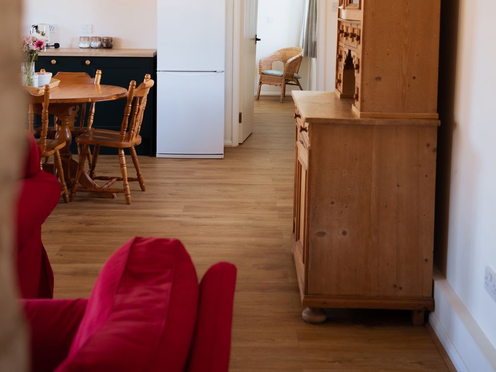 A kitchen with a table and chairs at Newfield Farm Cottages in Pimperne near Blandford Forum