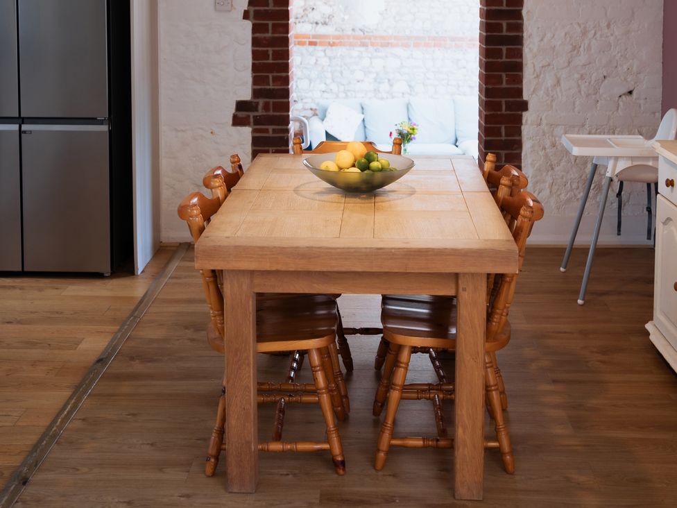 A dining room with a table and chairs at Newfield Farm Cottages in Pimperne near Blandford Forum