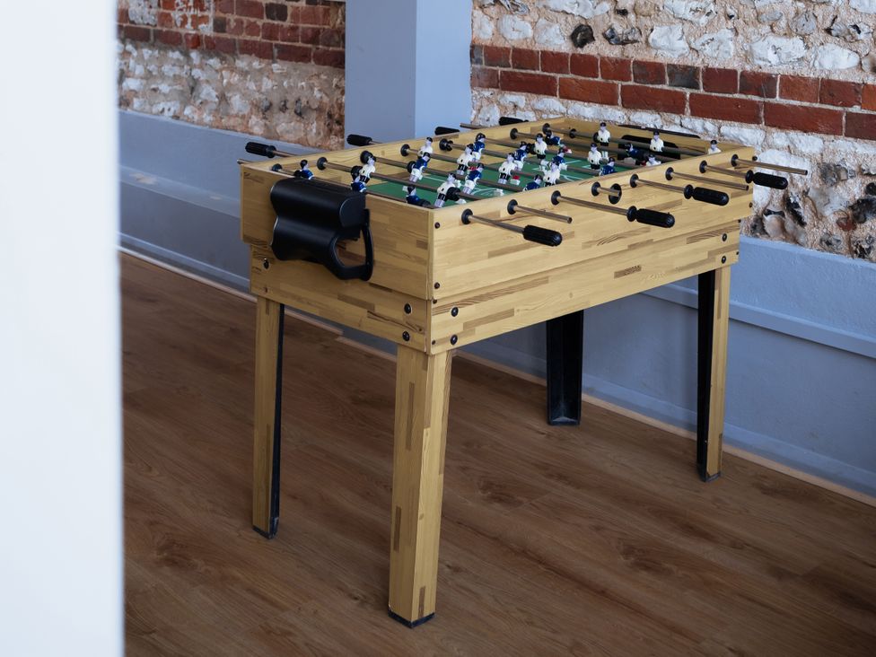 A foosball table in a recreation room at Newfield Farm Cottages in Pimperne near Blandford Forum