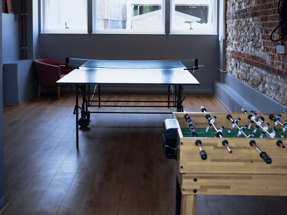 A game room with a table tennis table and a foosball table at Newfield Farm Cottages Pimperne near Blandford Forum