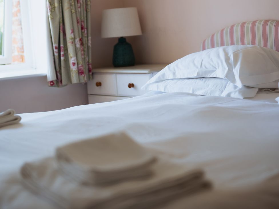 A bedroom with a bed and pillows at Newfield Farm Cottages Pimperne near Blandford Forum