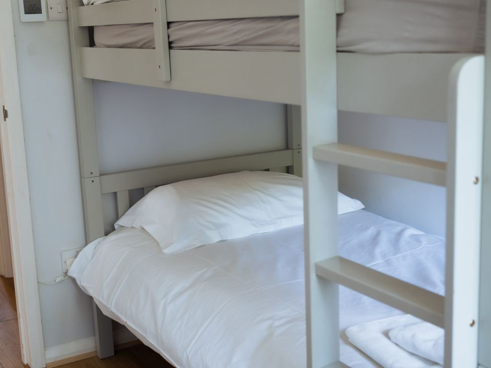 A bunk bed with blankets and pillows at Newfield Farm Cottages Pimperne near Blandford Forum