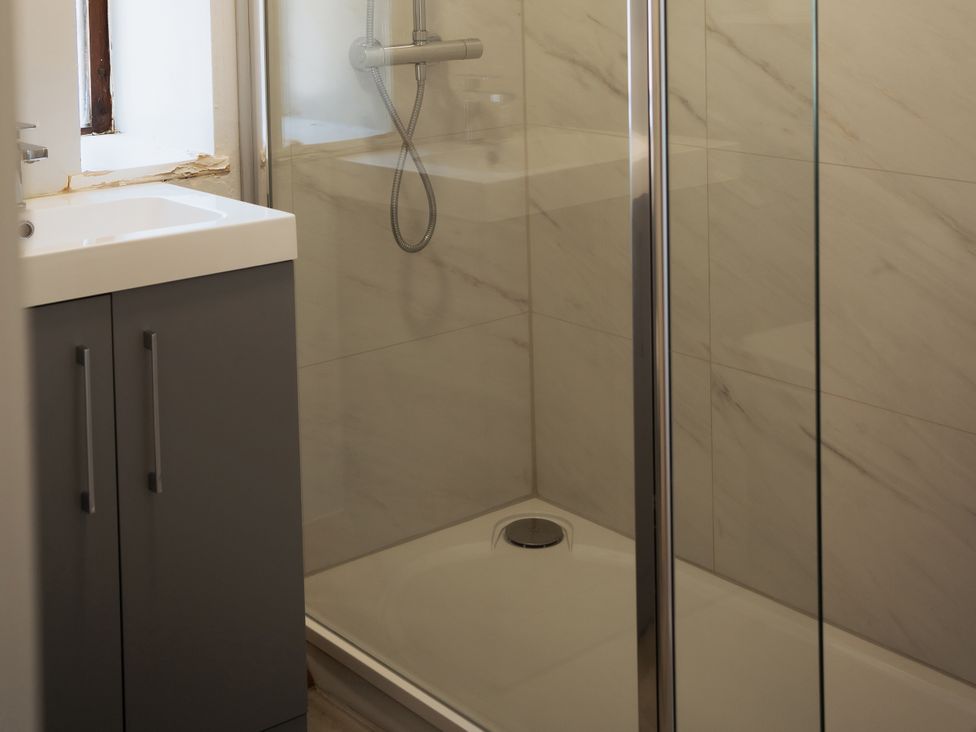 A bathroom with a shower and sink at Newfield Farm Cottages Pimperne near Blandford Forum
