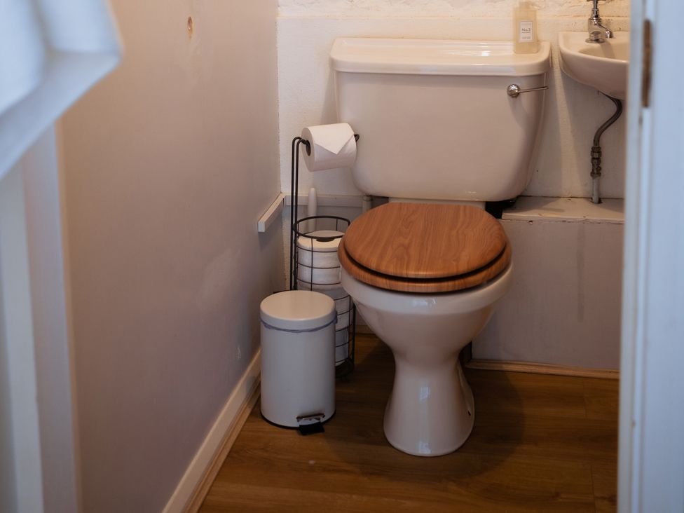 A bathroom with a toilet and sink at Newfield Farm Cottages Pimperne near Blandford Forum