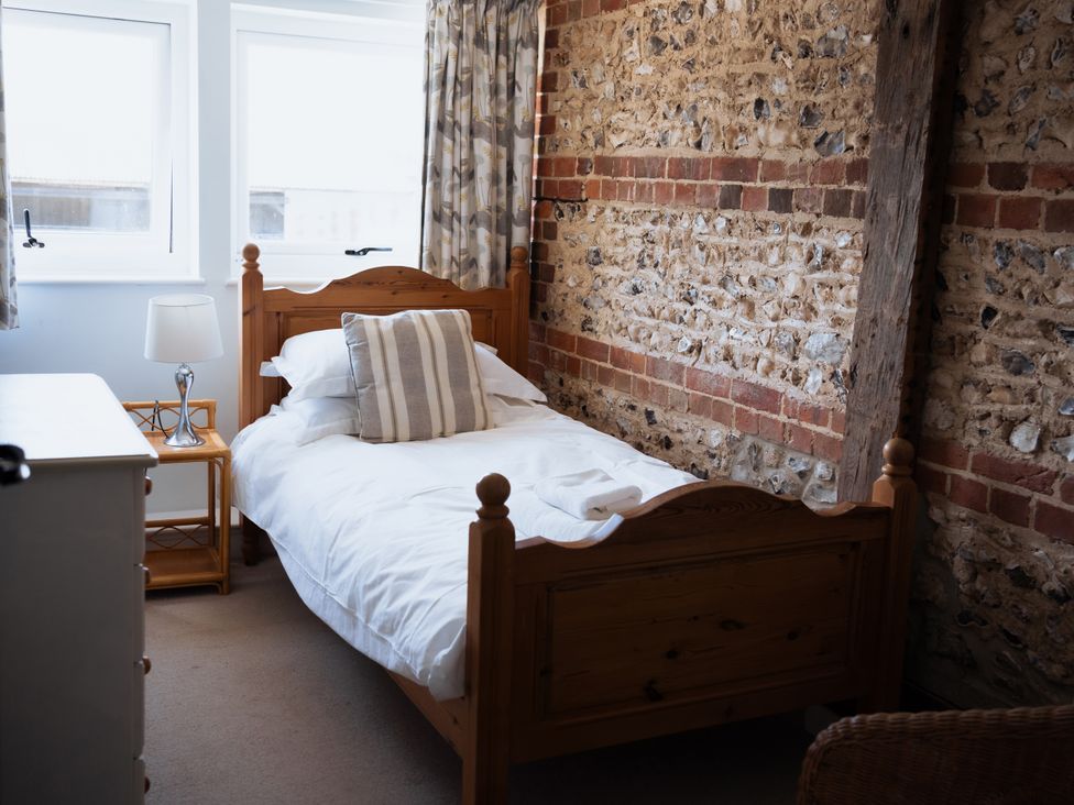 A bedroom with a bed and a lamp at Newfield Farm Cottages Pimperne near Blandford Forum