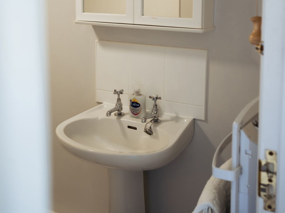 A sink with a soap dispenser at Newfield Farm Cottages Pimperne near Blandford Forum
