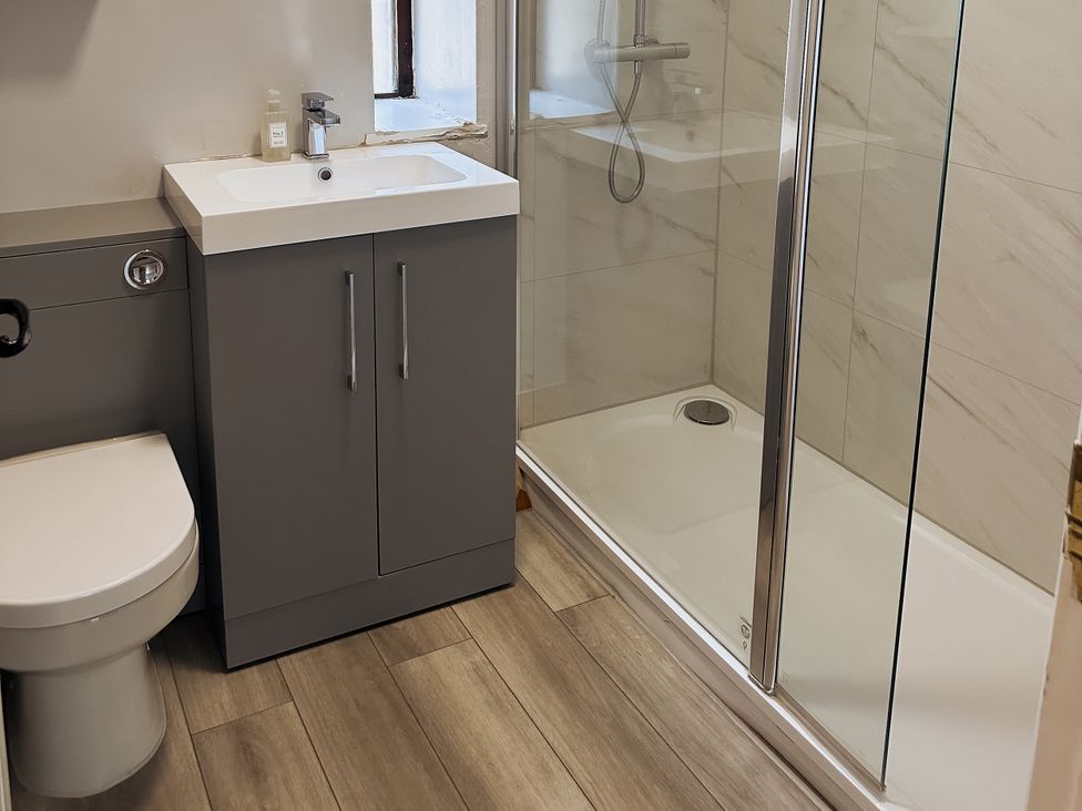 A bathroom with a toilet, sink and shower at Newfield Farm Cottages Pimperne near Blandford Forum