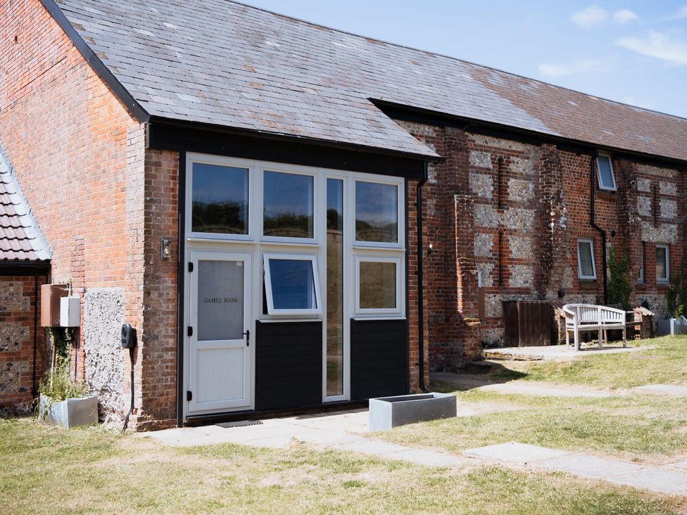 An outdoor view of the games room at Newfield Farm Cottages in Pimperne near Blandford Forum