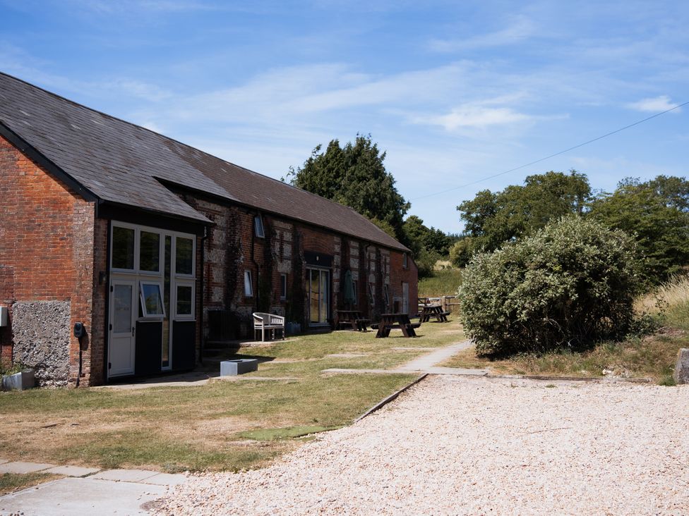 An outdoor area with a building and furniture at Newfield Farm Cottages in Pimperne near Blandford Forum