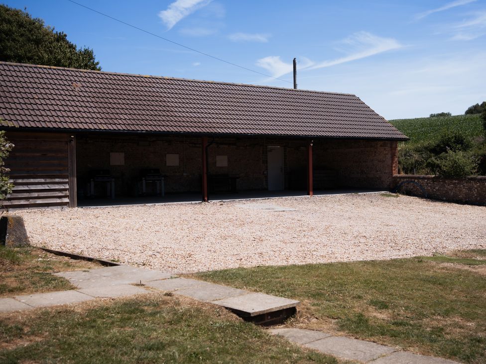 An outdoor area with a gravel surface and a building at Newfield Farm Cottages Pimperne near Blandford Forum