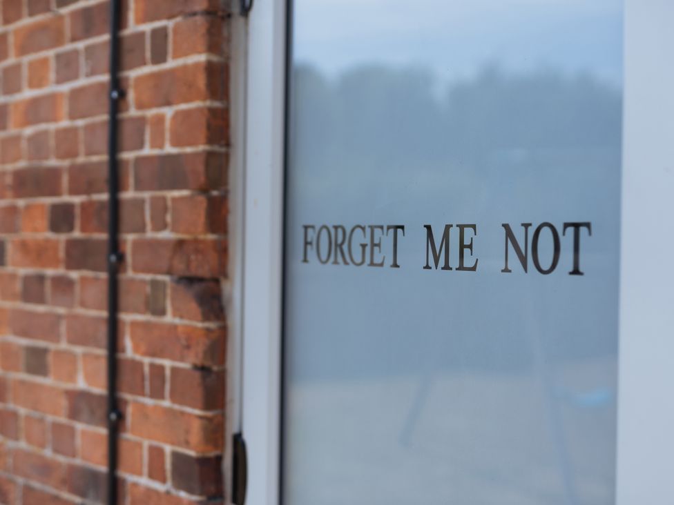 A door with 'FORGET ME NOT' text at Newfield Farm Cottages Pimperne near Blandford Forum