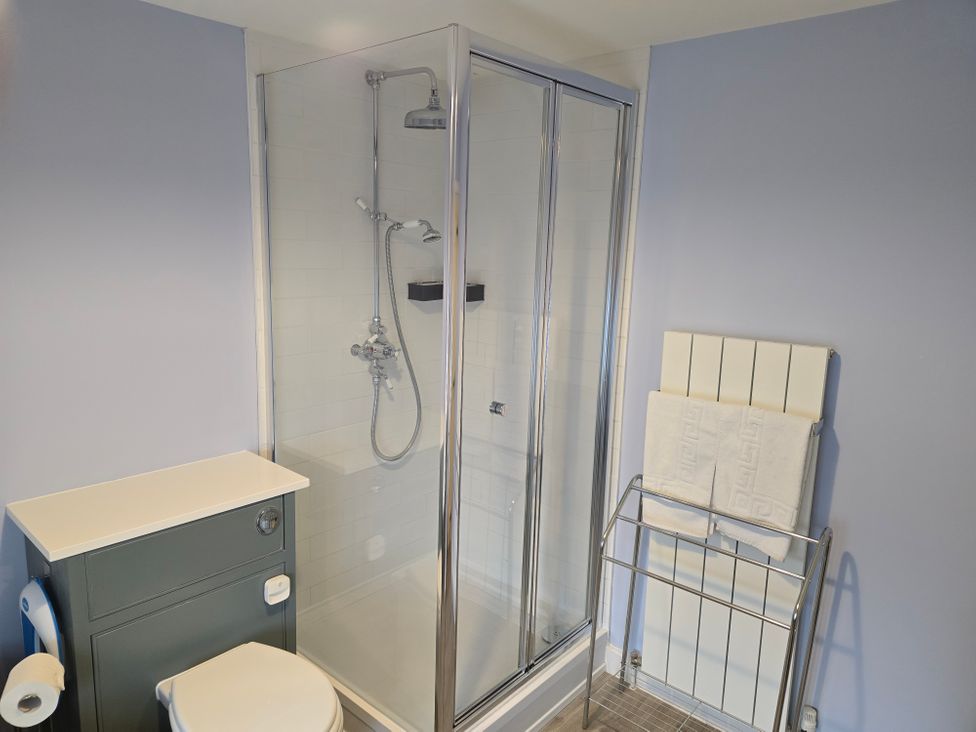 A bathroom with a shower and toilet at Granary Cottage in Warminster