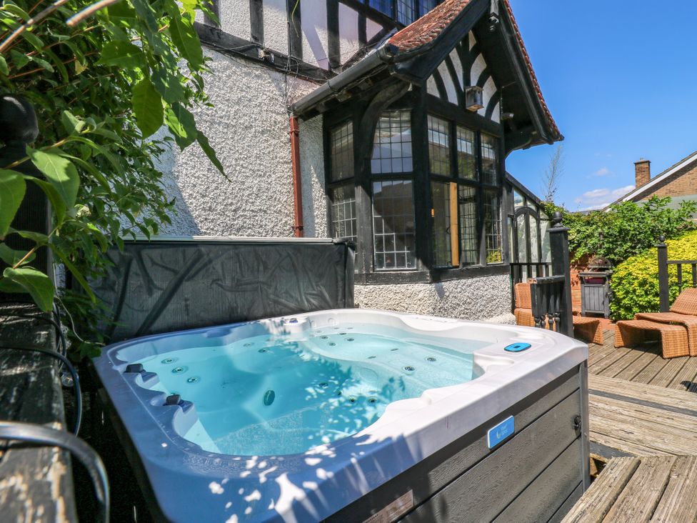 A hot tub on a deck outside the house at The Chestnuts in Peterborough