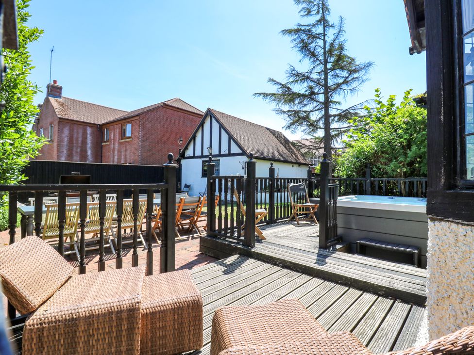 An outdoor area with a hot tub and sun loungers at The Chestnuts in Peterborough