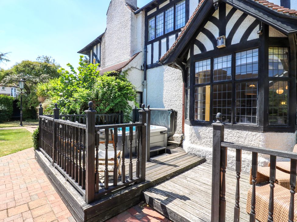 An outdoor area with a deck and spa at The Chestnuts in Peterborough