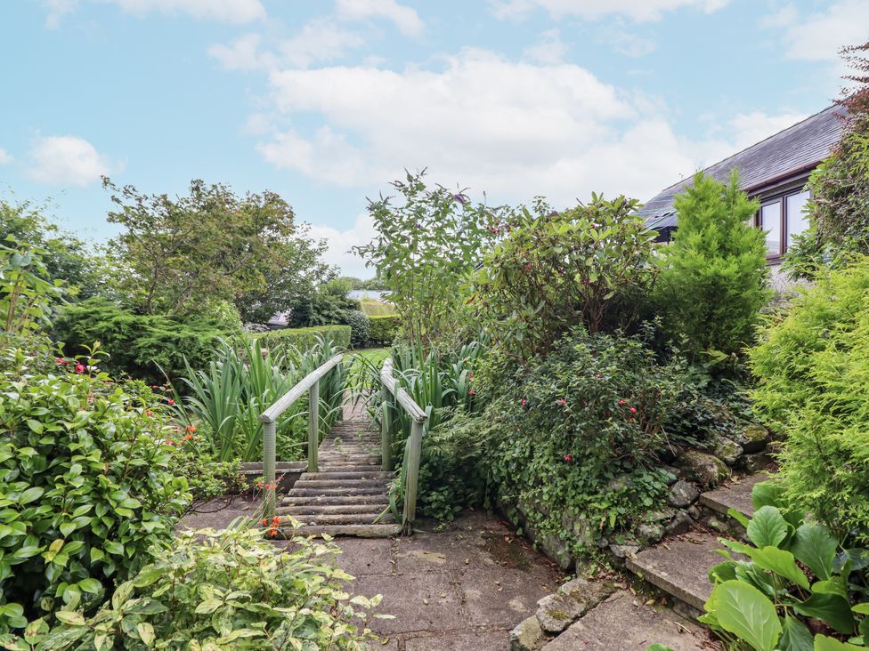 A garden with stairs, plants, and a pathway at 8 Glan Ysgethin Barmouth