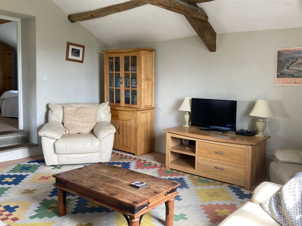 A living room with a coffee table and television at The Granary in Mansergh near Kirkby Lonsdale