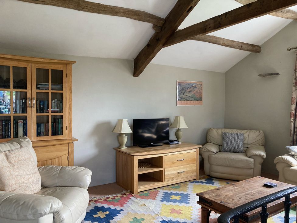 A living room setup with a sofa and television at The Granary Mansergh near Kirkby Lonsdale