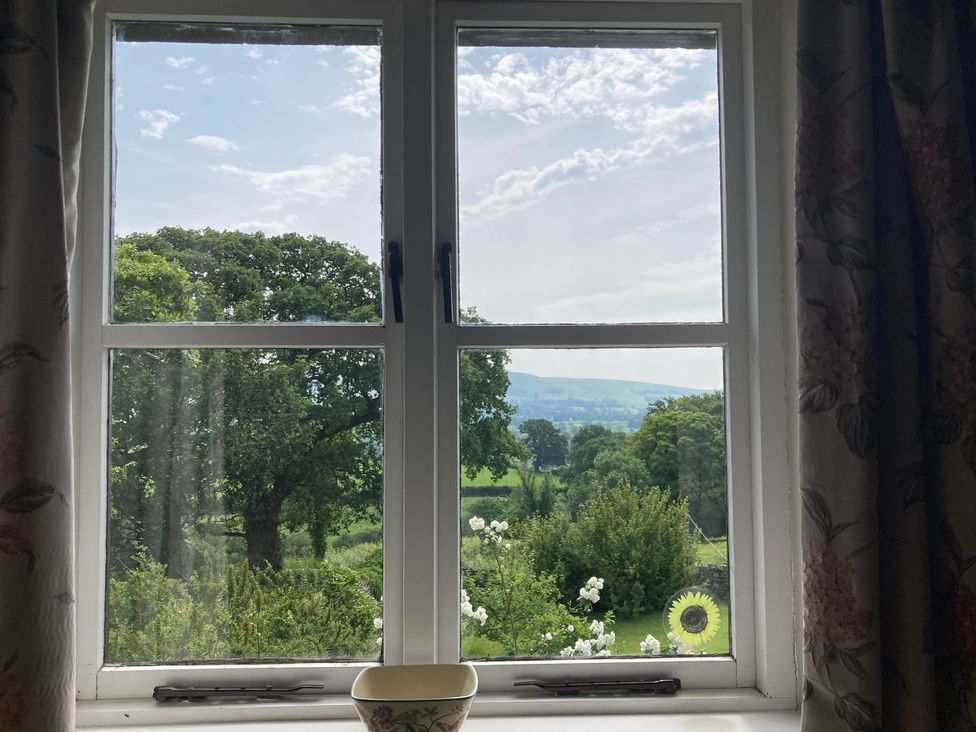A window view showing trees and a field at The Granary in Mansergh near Kirkby Lonsdale
