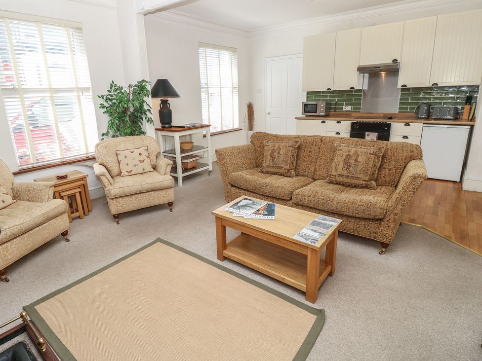 A living room with furniture and kitchen elements at Lancaster House in Sandown