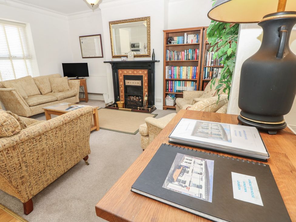 A living room with sofa and fireplace at Lancaster House Sandown