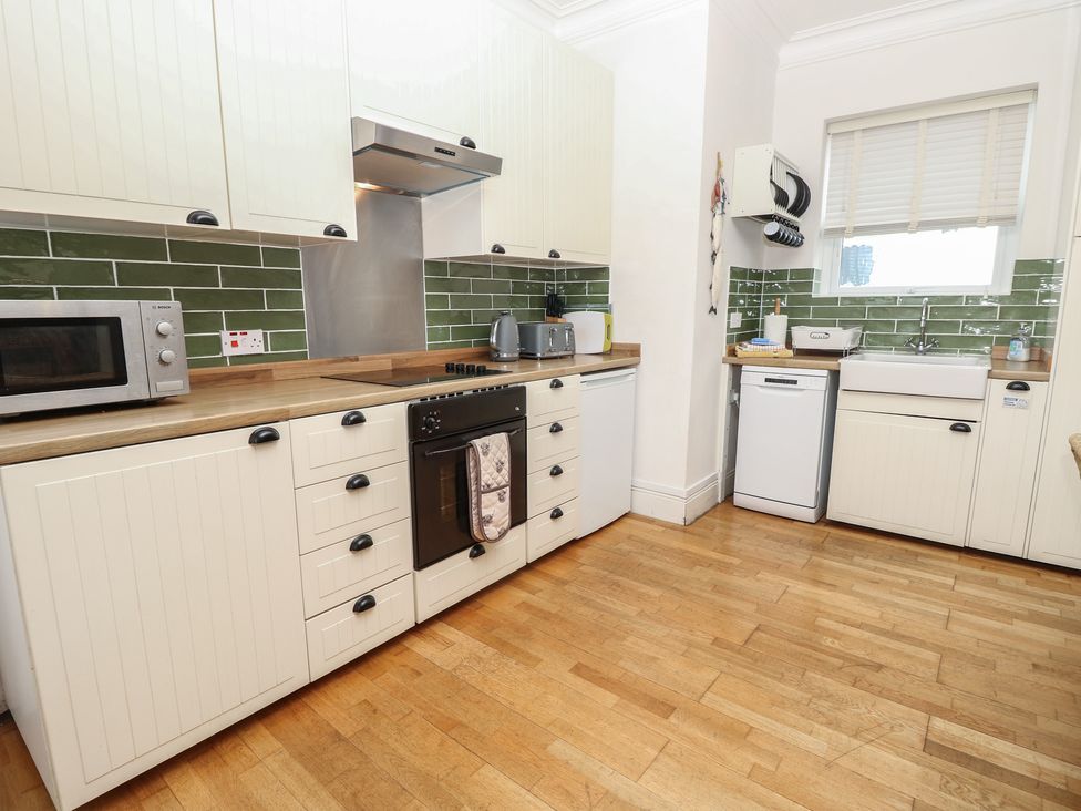 A kitchen with cabinets and appliances at Lancaster House Sandown