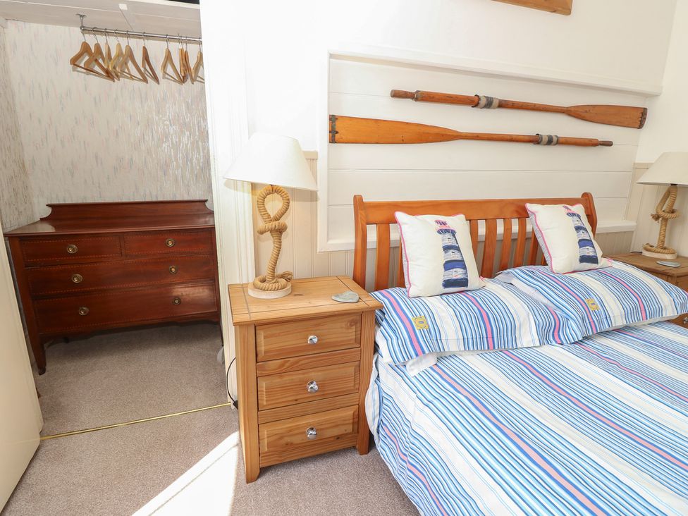 A bedroom with a bed and bedside table at Lancaster House in Sandown