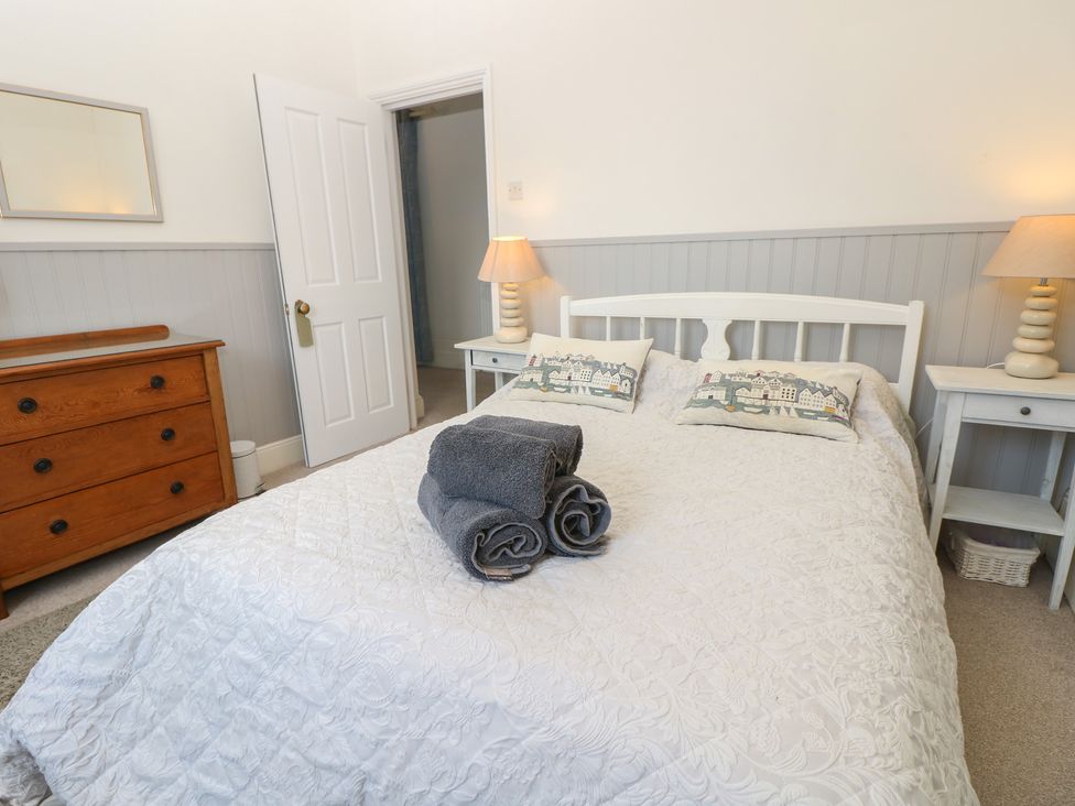 A bedroom with a bed and dresser at Lancaster House in Sandown