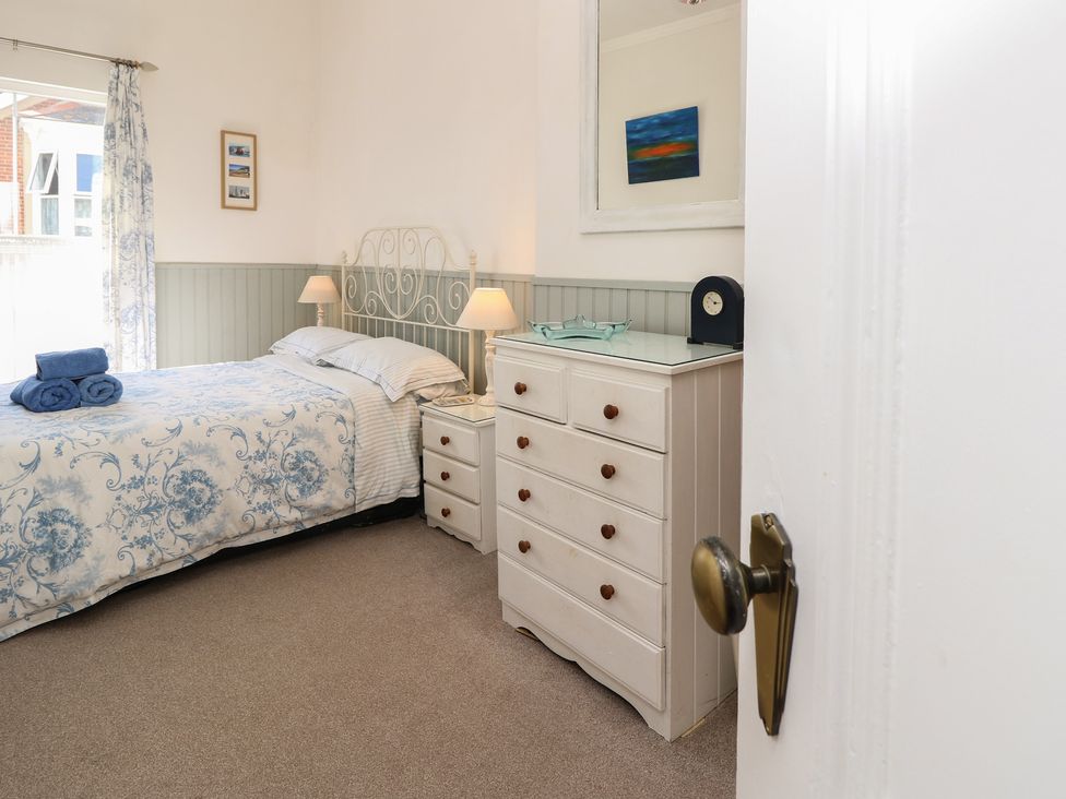 A bedroom with a bed and dresser at Lancaster House in Sandown