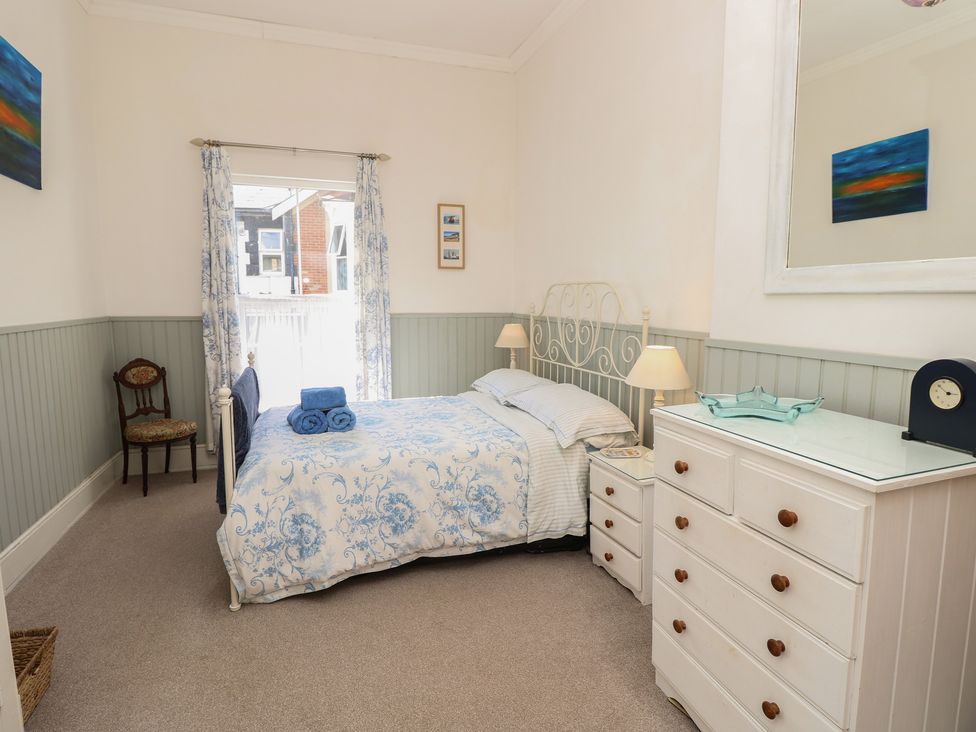 A bedroom with a bed and a chair at Lancaster House in Sandown
