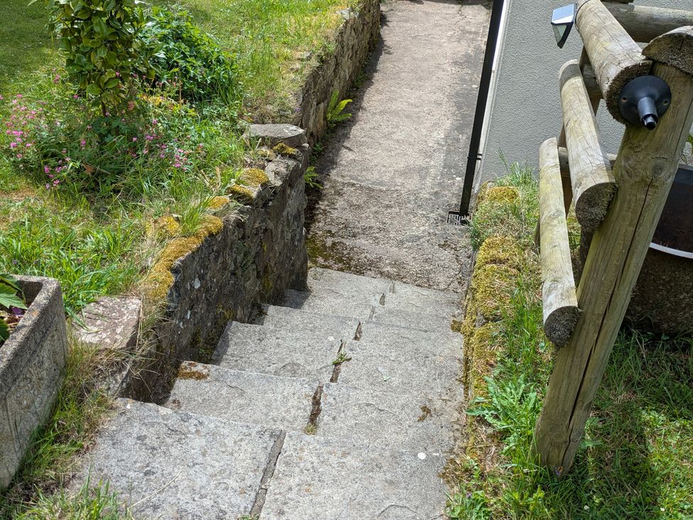Steps leading down to a pathway with grassy areas at Pool House The Narth near Trellech