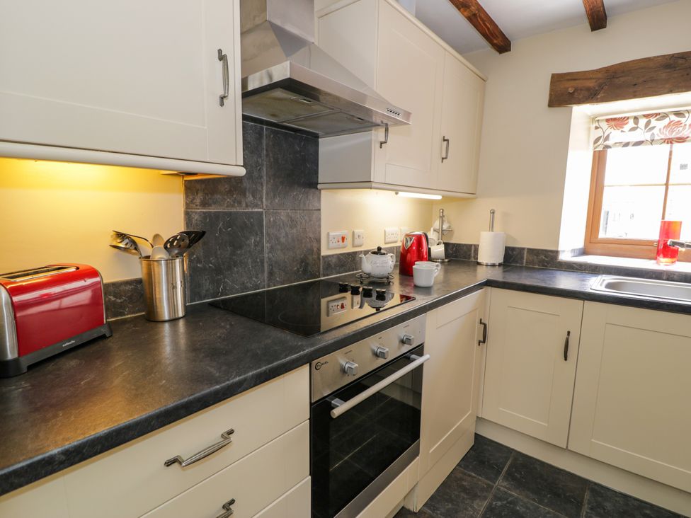 A kitchen with a stove and sink at Stabal-y-Gwedd in Dolwen near Abergele