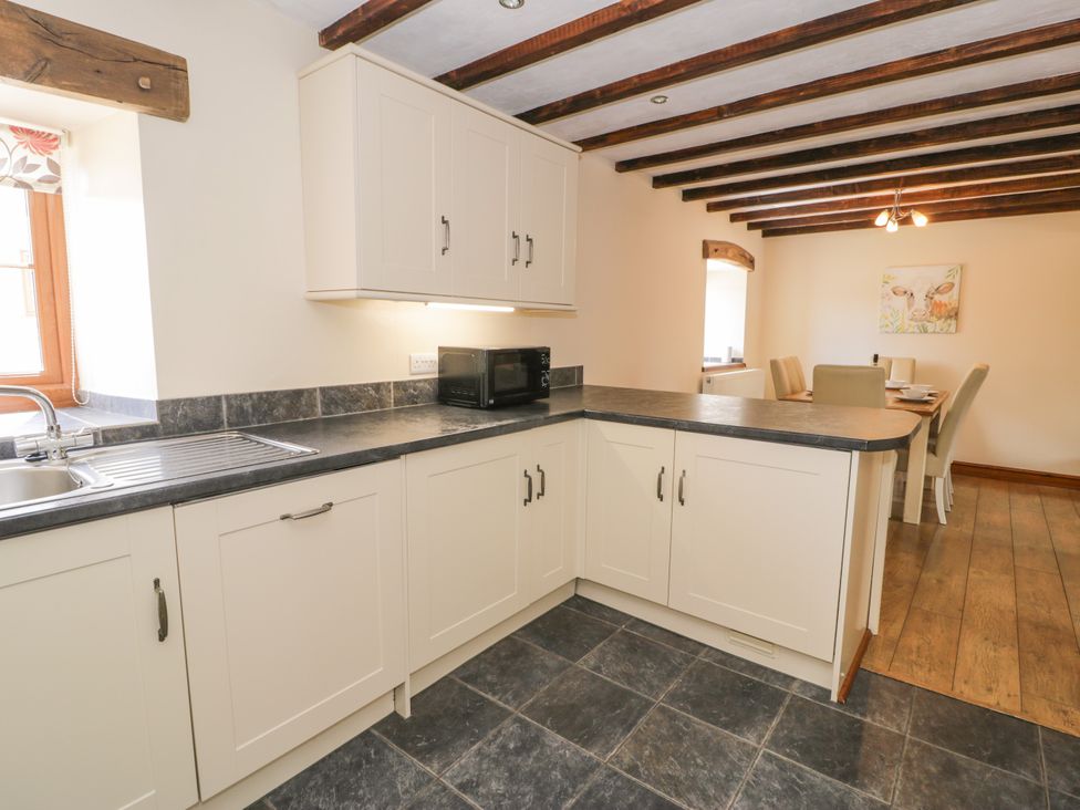 A kitchen with a sink and microwave at Stabal-y-Gwedd in Dolwen near Abergele
