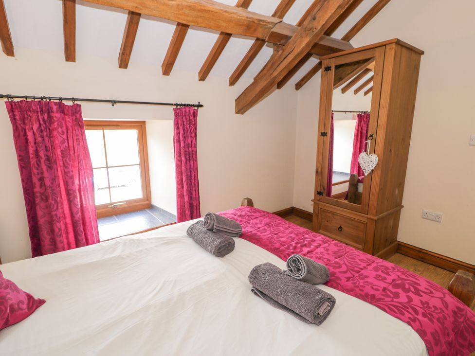 A bedroom with a bed and towels on it at Stabal-y-Gwedd in Dolwen near Abergele