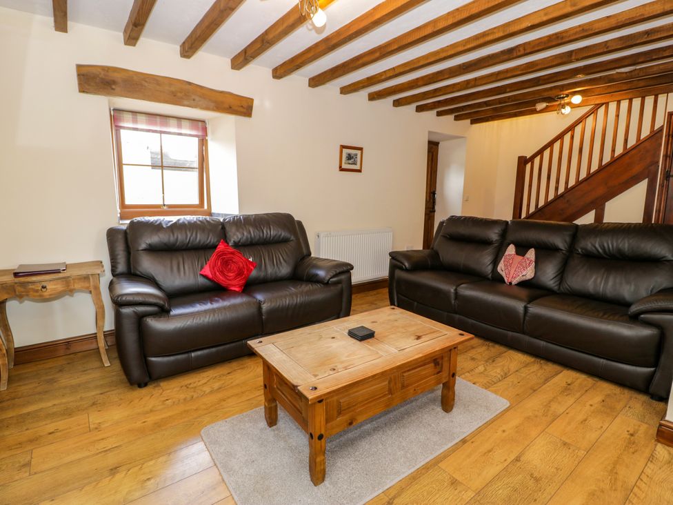 A living room with sofas and a coffee table at Beudy Bach Dolwen near Abergele