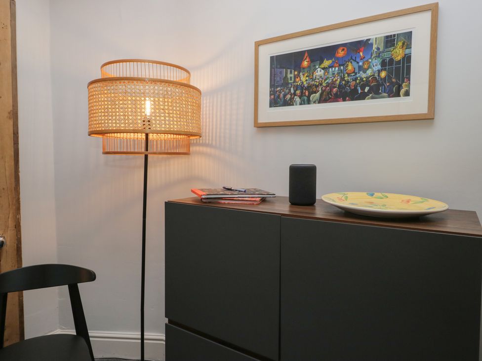 A room with a lamp, cabinet, picture, and a plate at Number Thirty-Nine in Ulverston