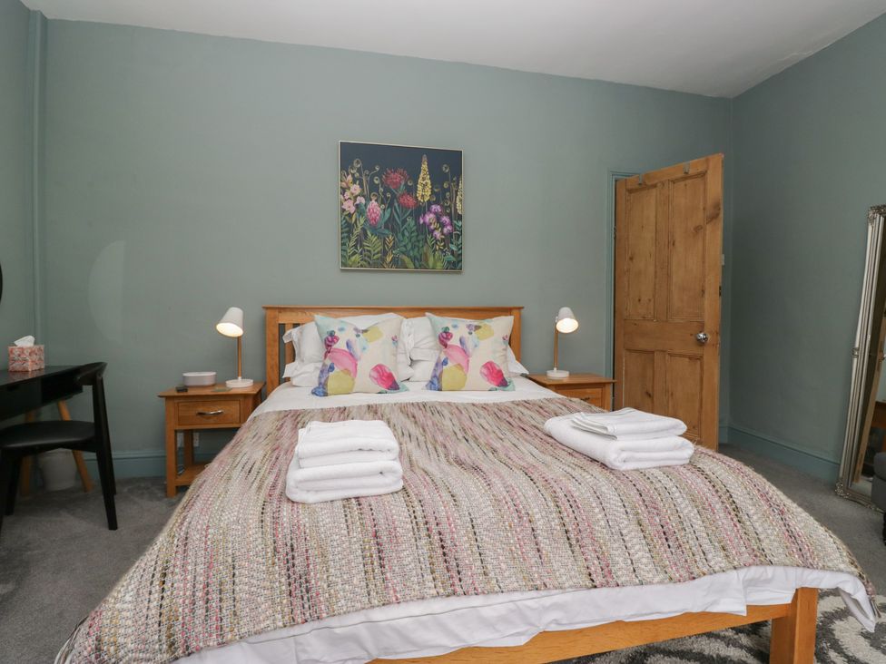 A bedroom with a bed and side table at Number Thirty-Nine in Ulverston