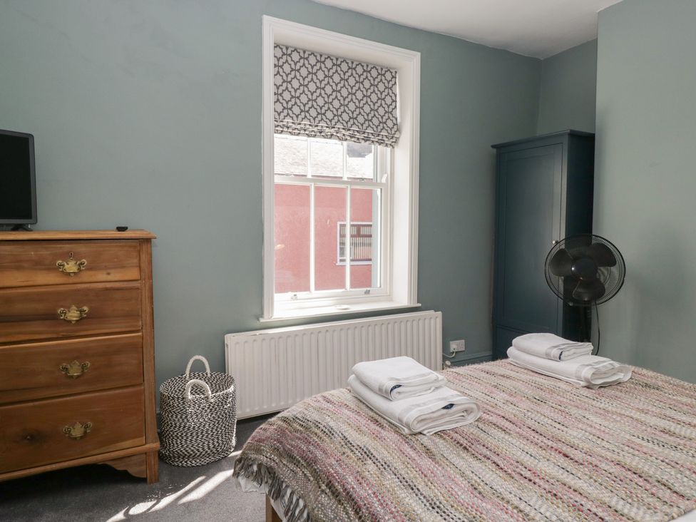 A bedroom with a bed and dresser at Number Thirty-Nine Ulverston