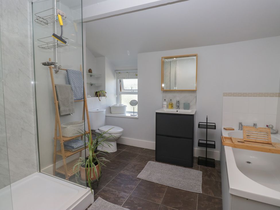 A bathroom with a shower, toilet, sink, and bath at Number Thirty-Nine in Ulverston